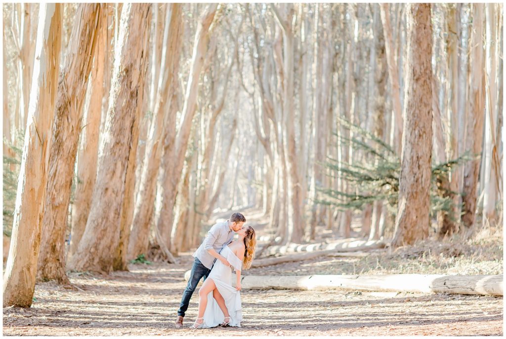 engaged couple kissing while dipping in the center of lovers lane